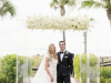 Bride and Groom in front of Beautiful Acrylic Canopy with White Flowers