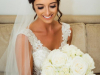 Bride with all white bouquet of spray garden roses and hydrangea