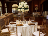 Elevated Guest Table Floral Arrangements of white hydrangea with curly willow and fairy lights