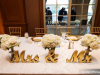 Head table with Mr. and Mrs. Sign and Bridesmaids' Bouquets in Vases