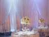 Elevated Table Centerpieces with White Roses on Double Bell  Vases and White Draping
