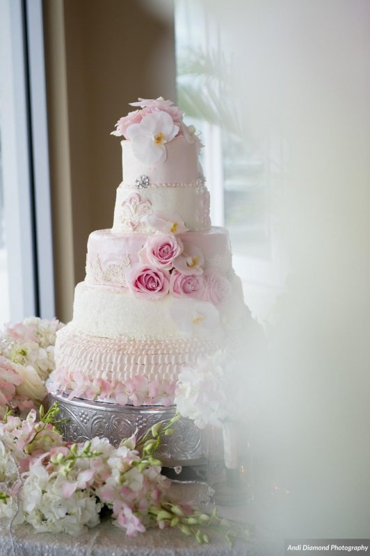 Beautiful Wedding Cake with Re-purposed flowers from Aisle flowers from Ceremony