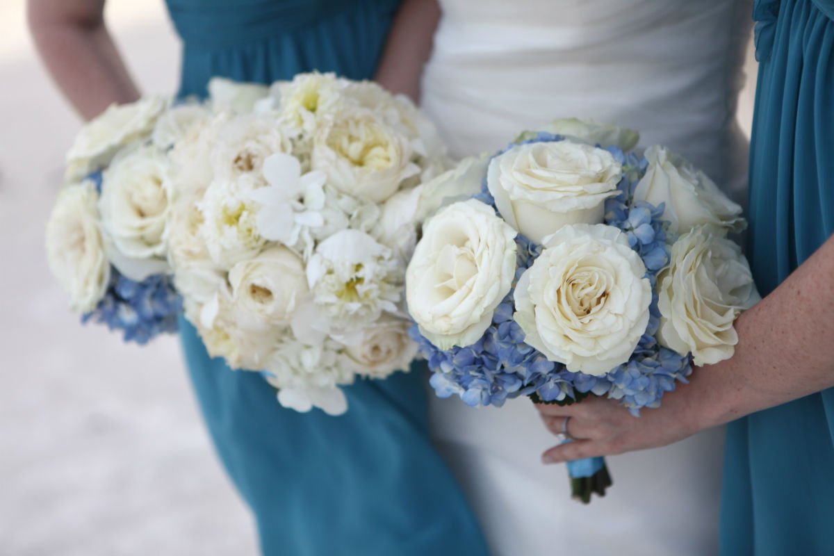 white bridal bouquet and blue and white bridesmaid bouquet
