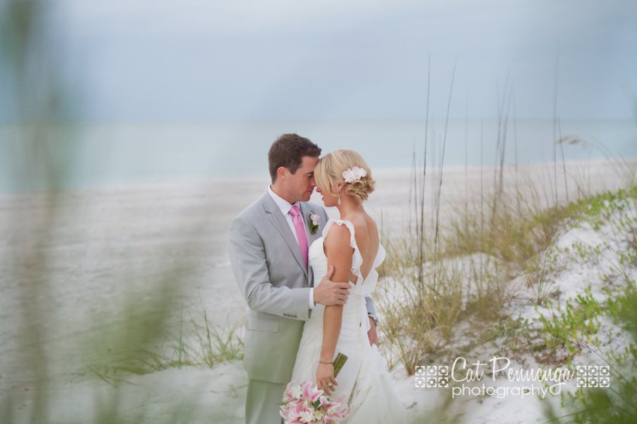 Bridge and Groom on the Beach with pink bouquet