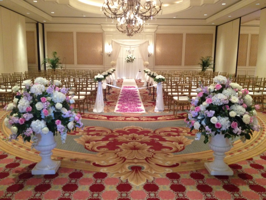 Wedding aisle with petals, urns, and chuppah