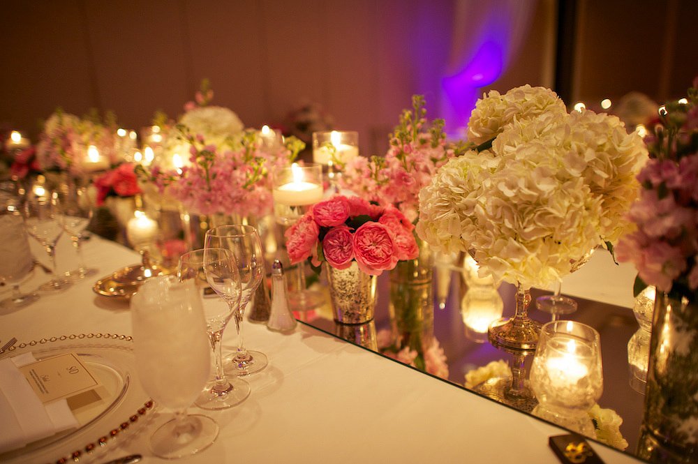 Feasting tables with mirror runners and candles