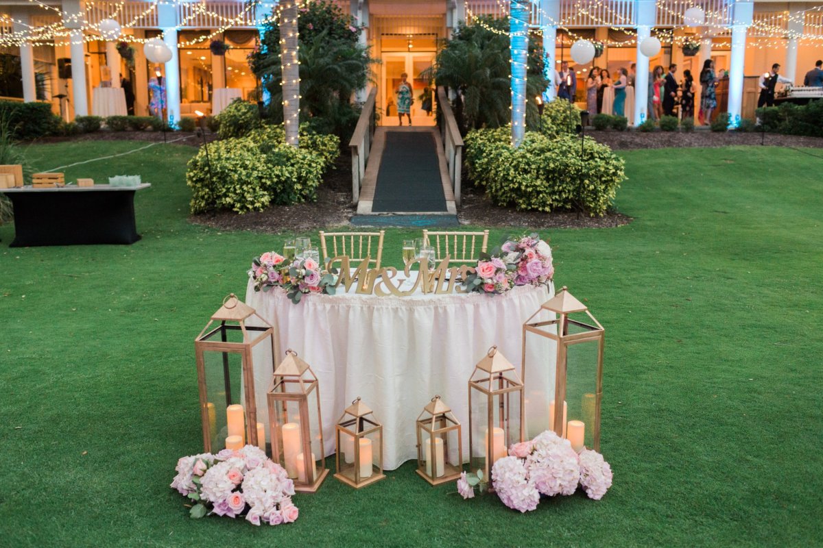 Sweetheart Table with Double-Duty Lanterns and Flowers from Wedding Ceremony