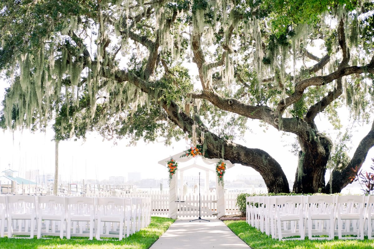 Wedding Site Under the Gazebo at Palmetto Bed and Breakfast with Orange, White Floral Sprays