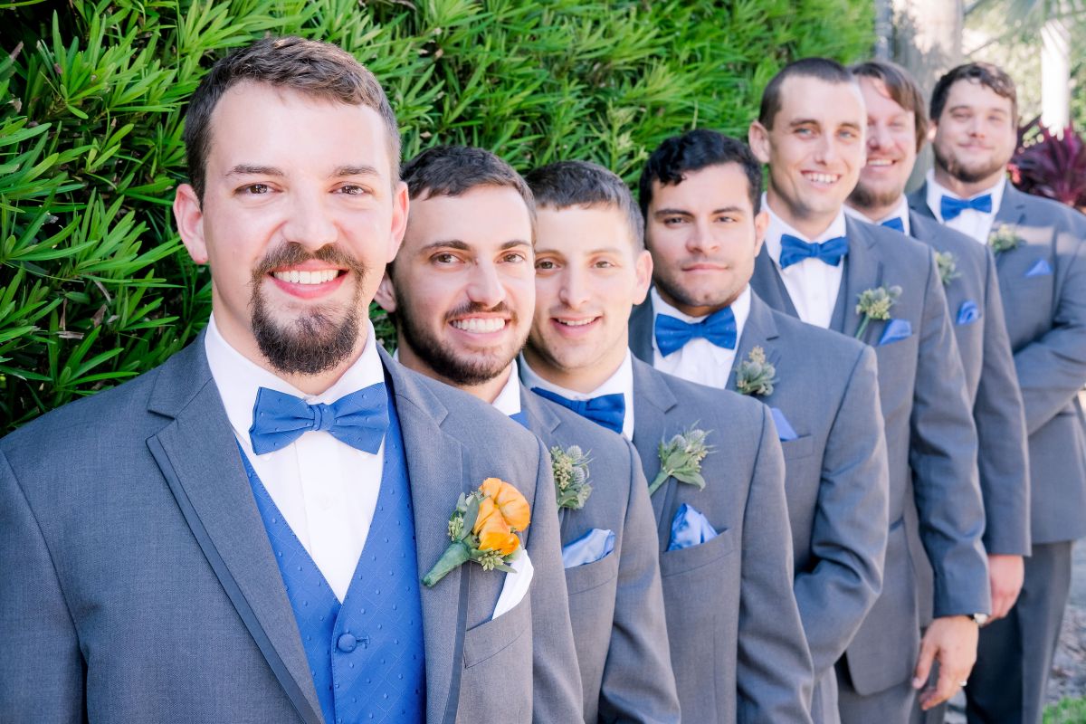 Groom with Orange Boutonniere and Groomsmen with Blue Thistle Boutonnieres