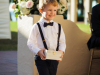 Ring Bearer  in front of Floral Arrangement at Entrance to Ceremony