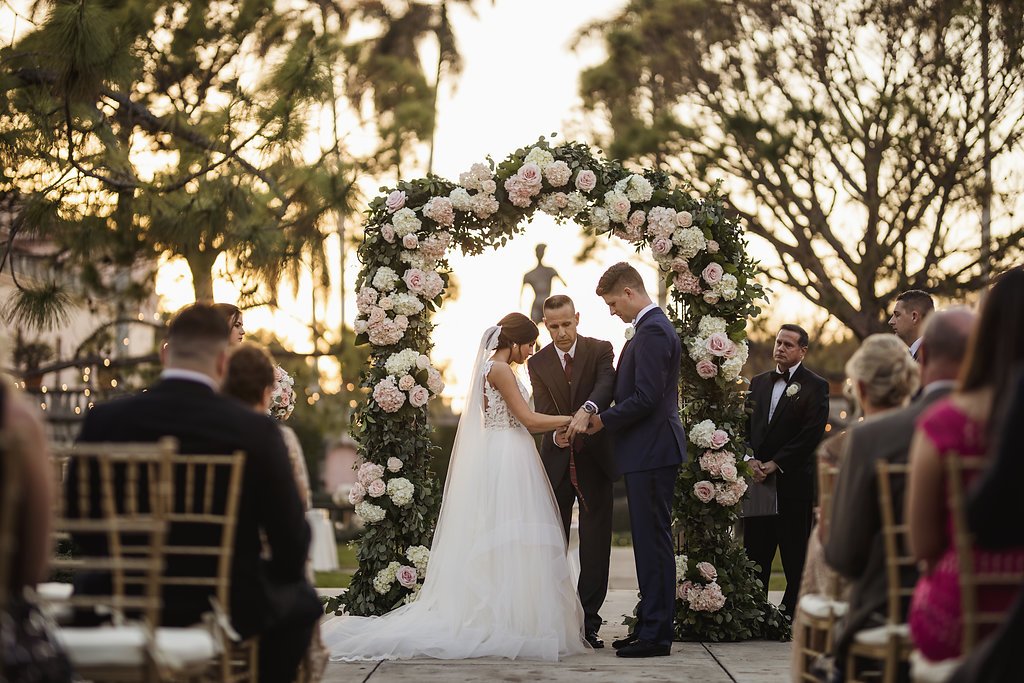 Couple Under Ceremony Arch in Ringling Courtyard with Statue of David in the Backgroun