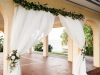 Wedding Ceremony Arch with Greens on Top and Two Floral Tie Backs