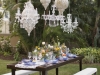 Small Wedding Feasting Table with Chandeliers and Assorted Floral Centerpieces of spring flowers and mixed vases