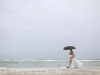 bride-and-groom-with-beach-umbrellas